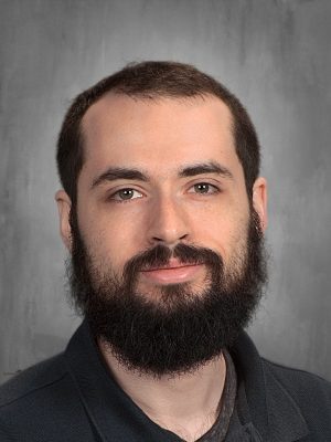 Portrait of James Clark, a man with a beard, looking directly at the camera.