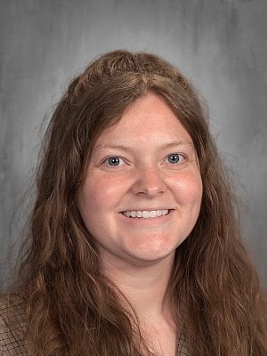 Brooke Ferguson headshot, smiling with long brown hair.